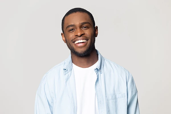 Handsome Black man with a fabulous smile from cosmetic dentistry treatment at D.A. Dental in Auburn, MA