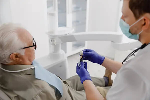 old man checking dental implants
